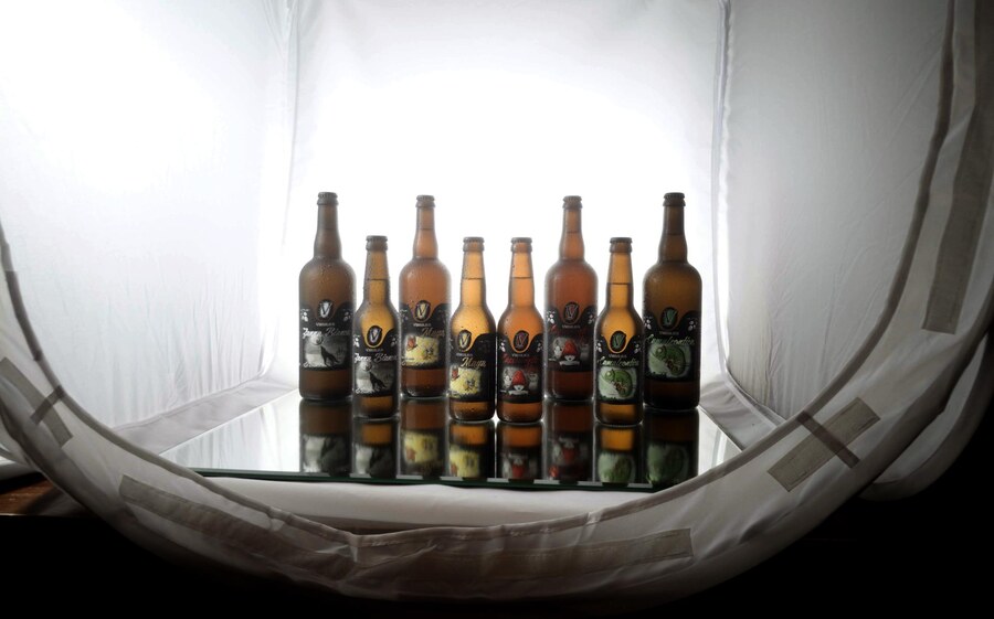 Home studio lightbox setup used to photograph all eight Virgilius bottle variants against a mirror