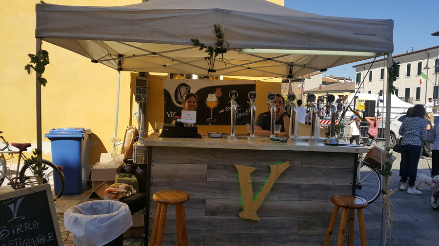 Claudio Falavigna, Birra Virgilius's owner, and his wife serving customers at the brewery's market stand
