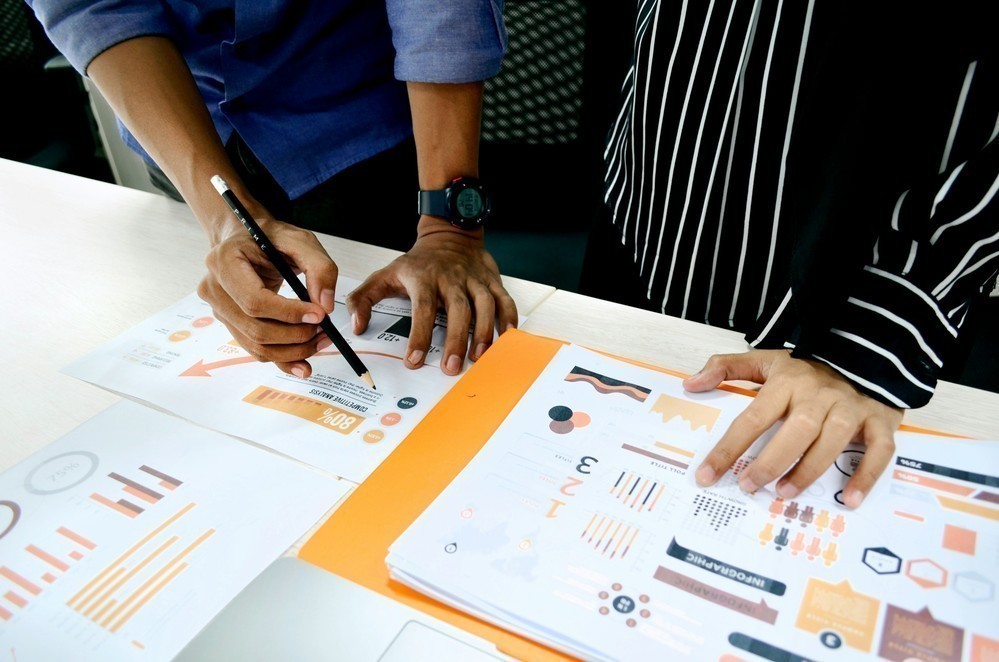 Team collaborating over UX research materials representing evidence and results